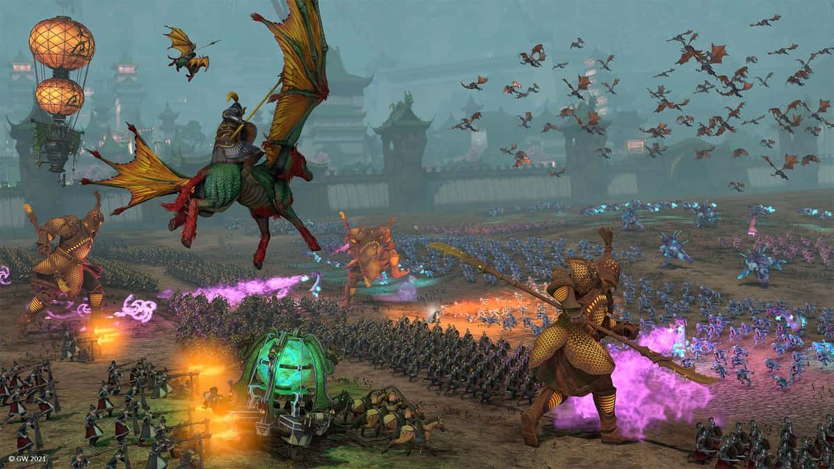 Bataille rangée entre armées fantastiques avec dragons et machines de guerre dans Total War : Warhammer III
