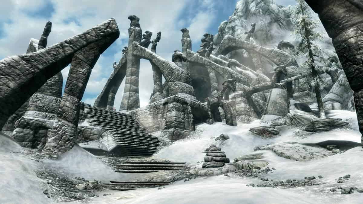 Ruines nordiques de pierre sculptée et escalier enneigé au pied d'une montagne